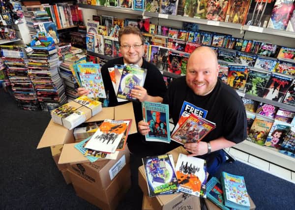Comic book shop co-owners Tom Trinder and Owen Lambert preparing for the big giveaway.ks170868-1 SUS-170205-185739008