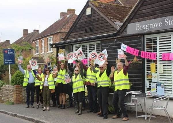 The group outside Boxgrove Stores with their signs on Monday