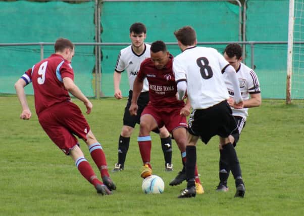 Wes Tate on the ball for Little Common against Bexhill United on Monday. Picture courtesy Catherine Gurney