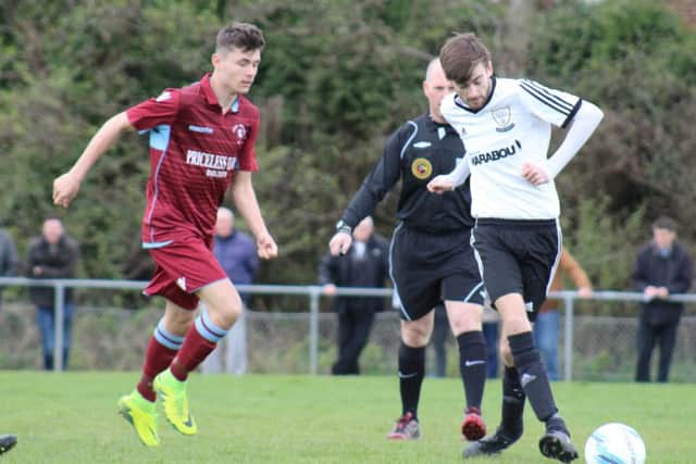 Nathan Lopez in possession for Bexhill United watched by Little Common midfielder Bradley Pritchard. Picture courtesy Catherine Gurney