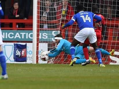 Crawley Town goalkeeper Glenn Morris gets down to make a save to deny Carlisle's Jamie Proctor.
Picture by PW Sporting Photography