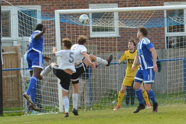 Melford Simpson heads home his second goal. Haywards Heath Town v Loxwood. Picture by Grahame Lehkyj