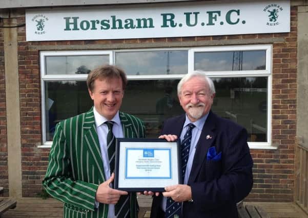 Brad Watson handing over a commemorative plaque to Richard Ordidge, vice chairman and commercial manager of Horsham Rugby Club