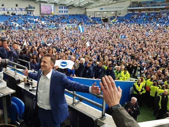 Tony Bloom in front of Albion fans on the Amex pitch after the Seagulls beat Wigan. Picture by Steve Bailey