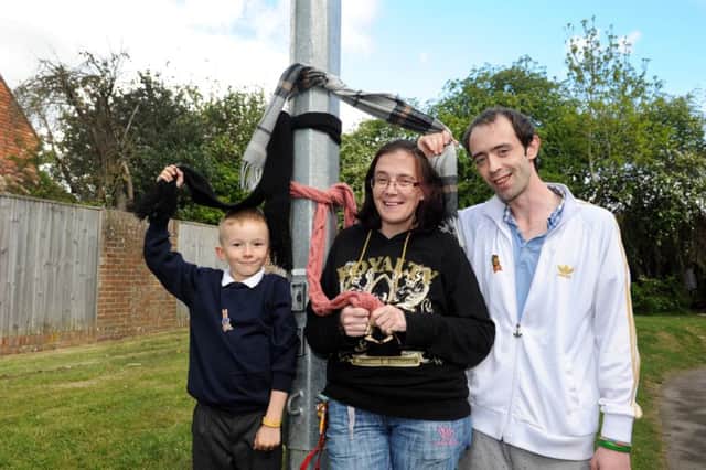 Chris Bedford, Claire Santa-Cruz and Kayden Frampton next to a lamp post in Eastbourne (Pic by Jon Rigby) SUS-170427-100813008