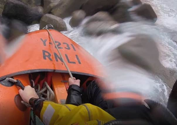 A lifeboat crew from Newhaven rescued two fisherman cut off by the tide on the rocks on the seaward side of the harbour arm. Picture: Newhaven RNLI