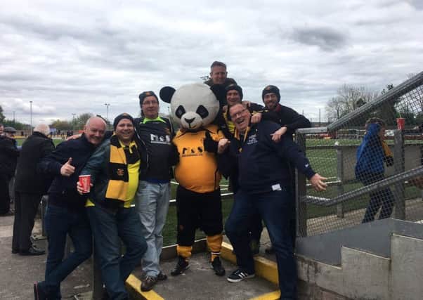 The group pose with the Annan Athletic football club mascot
