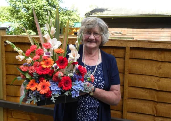 Ann Gray with one of the arrangements which won her the ISS Trophy for most points in floral art at the Arundel Festival Flower and Produce Show in 2013.