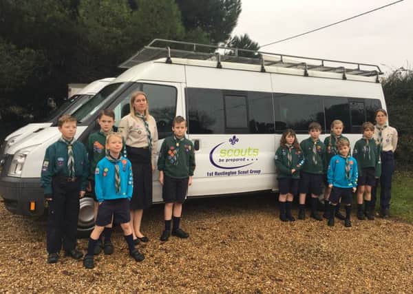 Members of the 1st Rustington Scout Group with the vandalised minibuses. Picture: Jo Lecuyer