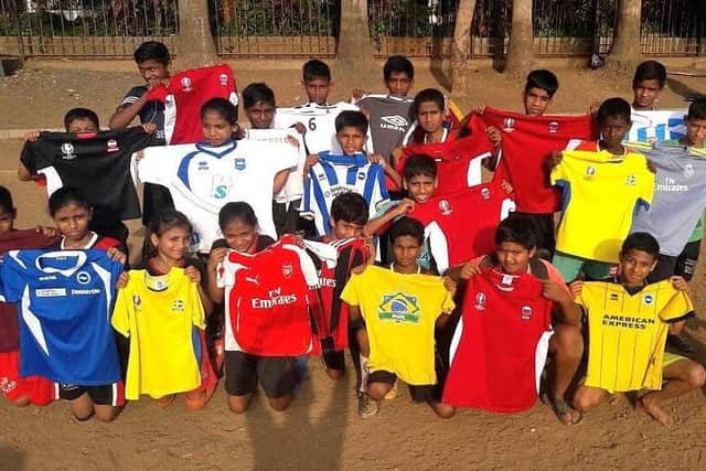 Children with some of the donated shirts