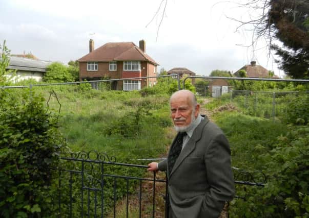 Retired social worker John Munro outside Greenhurst, part of the site of the possible retirement homes