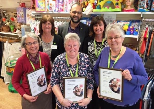 Chief executive Javed Khan with long-service award winners, front, from left, Pauline Jones, Audrey Groom and Ann Farmer, and mother and daughter Kay Fisher, store manager, and Eve Fisher, store associate