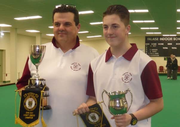 Ajay Morphett (right) with dad Rob after winning two titles at the county indoor finals in March.