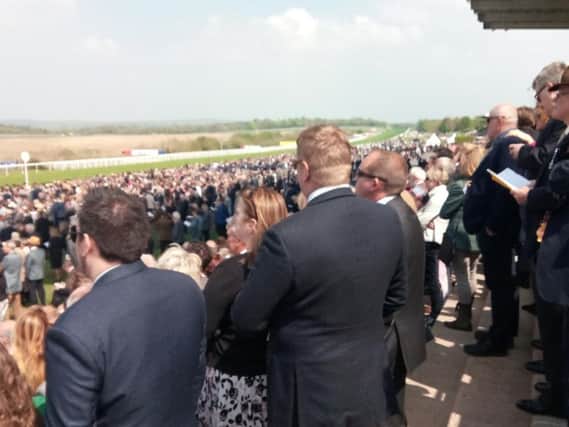 The large crowd looks on over the Downs in the sunshine