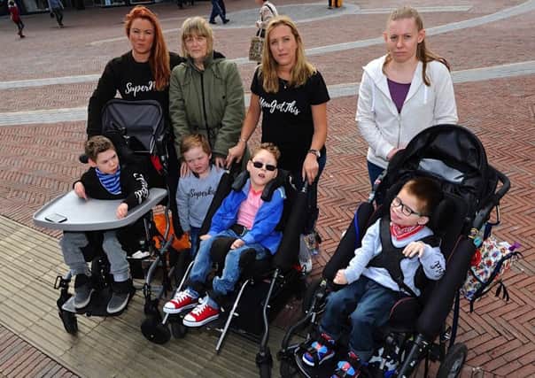 Parents are angry about the lack of a disabled changing facility at the new Next in Rustington. Pictured second from right is Laura Moore with her son William. Picture: Stephen Goodger