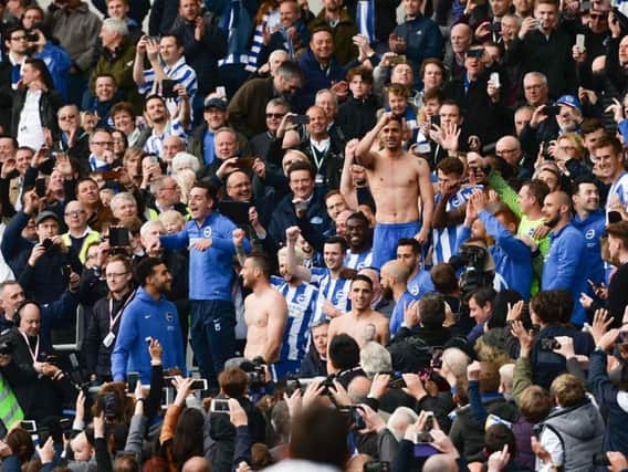 Lewis Dunk leads the celebrations as Brighton & Hove Albion celebrate their promotion to the Premier League