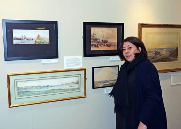 Emma OConnor, museums officer at Sussex Archaeological Society, with some of the paintings. Pictures: Derek Martin DM17523246a