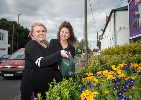 Steph and Kelly from the Raire Hairdressing Company Salon in Wick Village water the new plants on a sunny day. Picture: Scott Ramsey