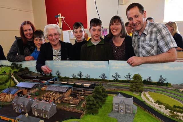 Lois Dedman, third left, shows her family and grandchildren her late husband Ted's railway layout, which was on show at Sompting and District Model Railway Club's annual exhibition for the first time. Picture: Stephen Goodger