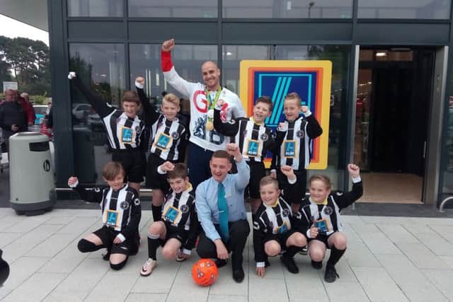 Players from the Rustington Otters youth football club, store manager Steve Newlyn-Bowmer and olympian Liam Heath open the Aldi in Manor Retail Park, Rustington