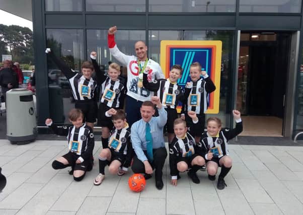 Players from the Rustington Otters youth football club, store manager Steve Newlyn-Bowmer and olympian Liam Heath open the Aldi in Manor Retail Park, Rustington