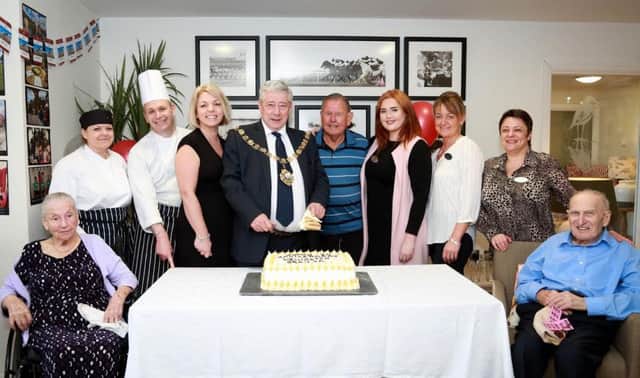 Slice of the action: Chichester Mayor Cllr Peter Budge joined home manager Clare Gibson, staff and residents at Colten Care's Wellington Grange care home to celebrate its first birthday with a glorious garden party