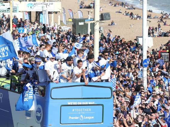Brighton and Hove Albion players on the open-top bus parade through the city (Photograph: Eddie Mitchell)