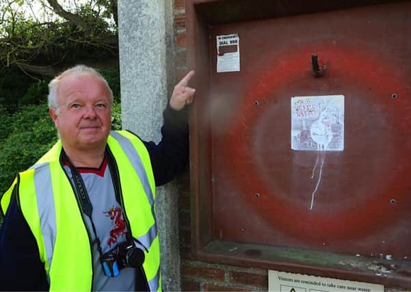 Clive Fennell with the stolen life buoy. Picture: Stephen Goodger