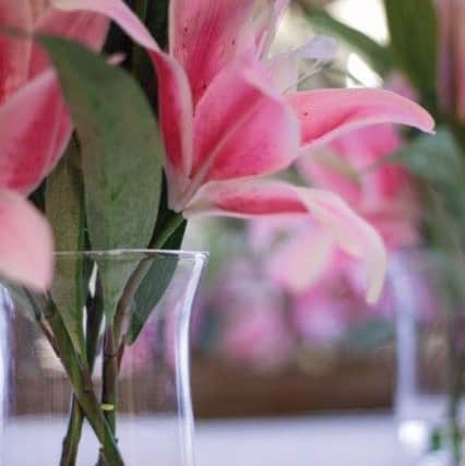 Artificial lilies in flared vase, Â£44.99
