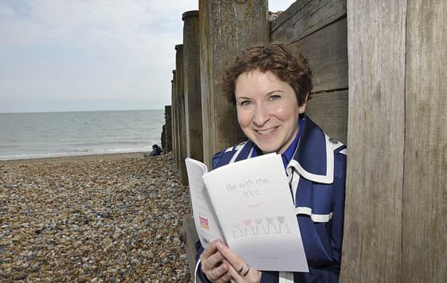 Avril Chester is pictured on Eastbourne seafront with her book