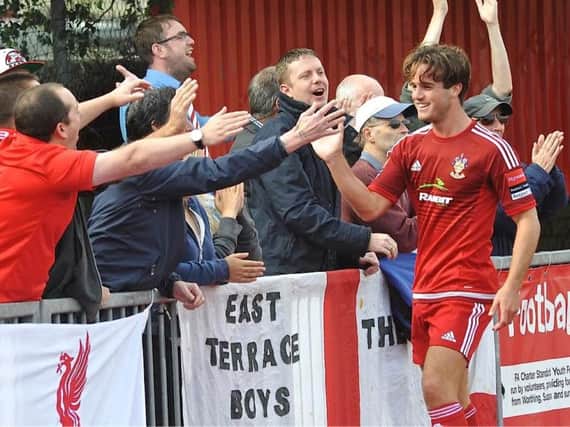 Brannon O'Neill celebrates a goal with Worthing's fans. Picture by Stephen Goodger