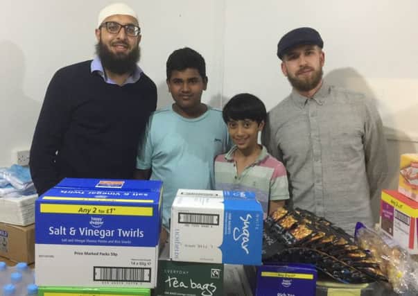 Sajid Khan (left) alongside two of his students, Ateef and Shabick  and volunteer Yousef