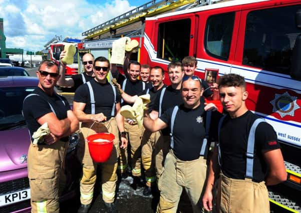The firefighters who washed cars for charity in Morrisons car park. Picture: Kate Shemilt ks170918-1