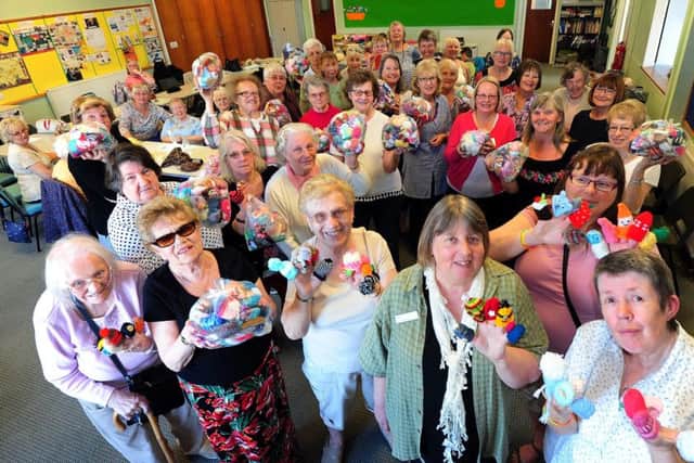 ks170920-1 LG Knitted Smoothie Hat  phot kateMembers of the Arcade Knitters in Littlehampton handed over their bags of hats to Dianne Henderson, chief executive fom Age UK, front second right.ks1709201-1 SUS-170521-165906008