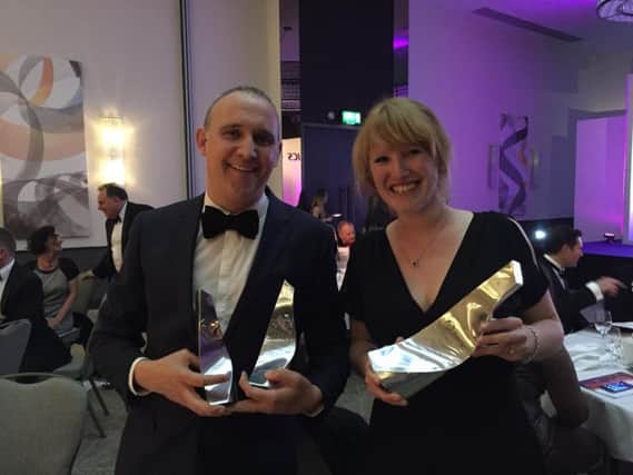 Marks Barfield Architects director Ian Crockford and architect Georgina Vizor clasp three trophies at the annual South East RICS Awards, at which British Airways i360 won Project of the Year