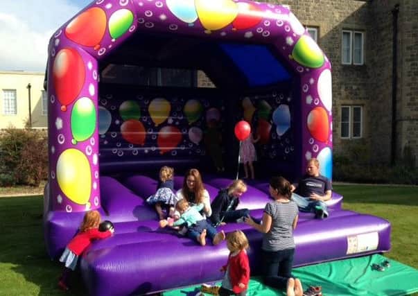 Children having fun on the bouncy castle at a Grace Church event