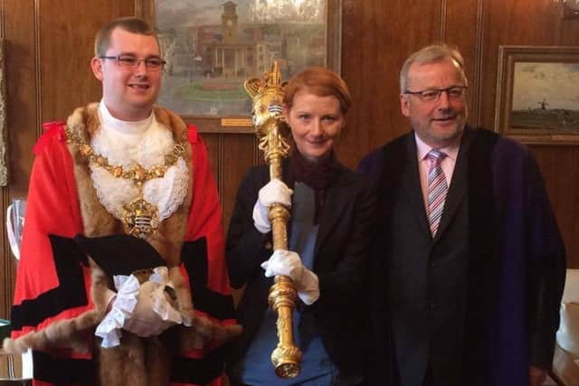 Worthing mayor making 2017. Councillor Sean McDonald, right, hands over the duty to Alex Harman, Worthing's youngest mayor, left.  Centre is Mary D'Arcy, director for communities and macebearer for the day. SUS-170519-142232001
