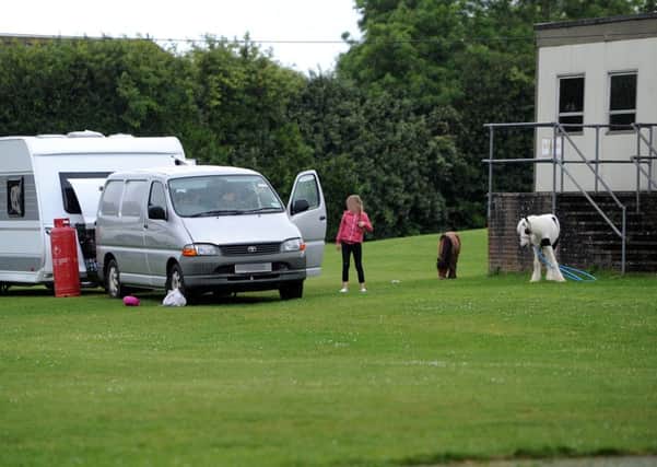 Police speak to travellers who broke into playing fields at Hazelwick School, Crawley. Photo: Steve Robards SUS-170519-153232001