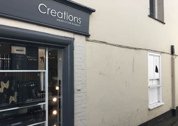 The broken window at the side of Creations in Chichester