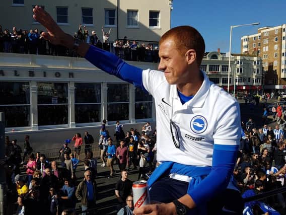 Steve Sidwell waves to fans at the promotion parade.