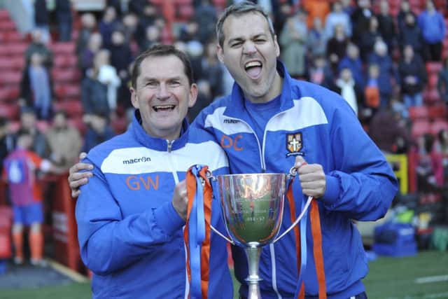 Battle manager Gary Walsh (left) and coach Dan Collins celebrate with the trophy.