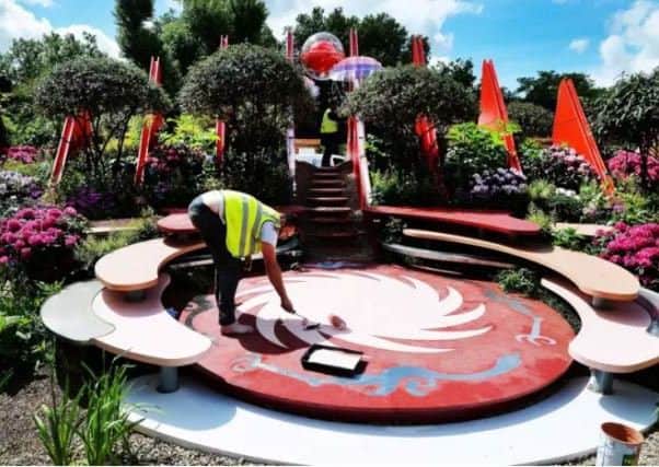 FINISHING TOUCHES: An exhibitor works on final preparations at the world famous RHS Chelsea Flower Show in London before the event opens to the public.