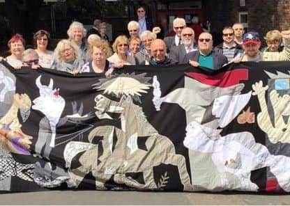 At the unveiling, with a mural of Picasso's Guernica. Photo: Sophie Cook