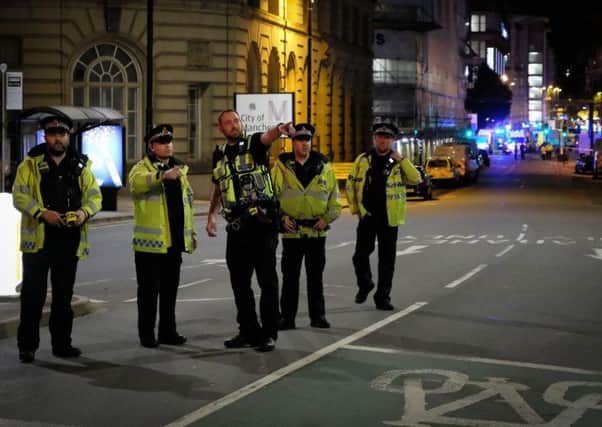 Police near the scene of the explosion in Manchester last night. SWNS
