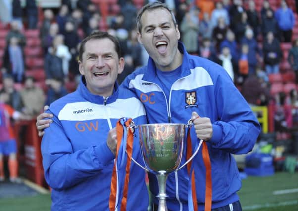 Battle Baptists manager Gary Walsh (left) and coach Dan Collins celebrate with the trophy.
