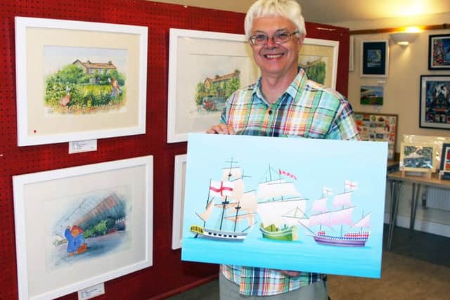 Peter Scott, joint winner of the Audrey Benson Memorial Cup, holding one of his paintings at Southwick Art Group's annual exhibition. Photo by Derek Martin DM17525565a