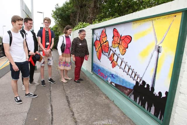 Some of the students showing Guild Care representatives their artwork DM17525301a