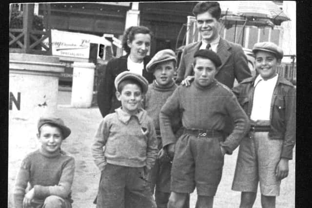 Cayetana Lozano DÃ­az and James Jump with some of the refugee children in Lancing in 1937