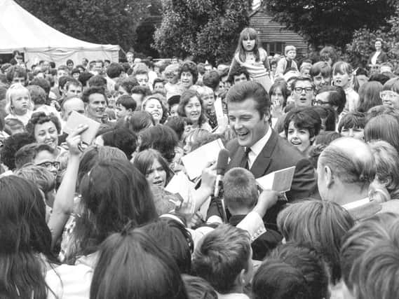 Roger Moore surrounded by a sea of fans in 1968