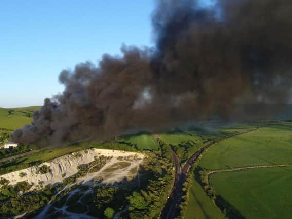 Plumes of black smoke spread over the Sussex coastline. Photo by Eddie Mitchell.